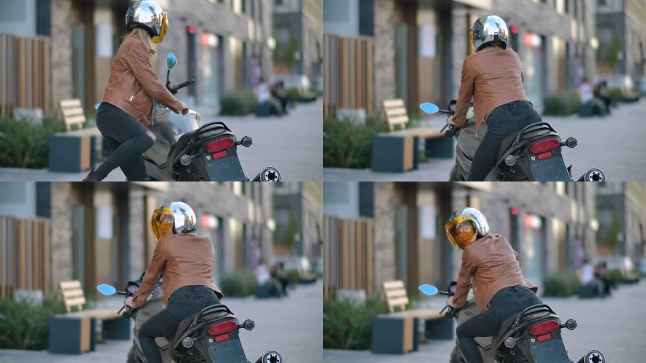 特写骑自行车的女人穿过停车场走到他在城市的站立摩托车上。概念摩托车手和摩托车。后侧视图女孩司机坐在城