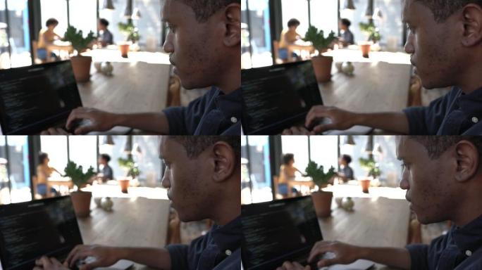 在咖啡馆使用笔记本电脑的软件工程师
