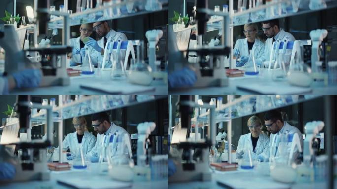 女性和男性医学研究科学家在用生物DNA样本进行试管和烧杯实验时进行了交谈。现代科学实验室。