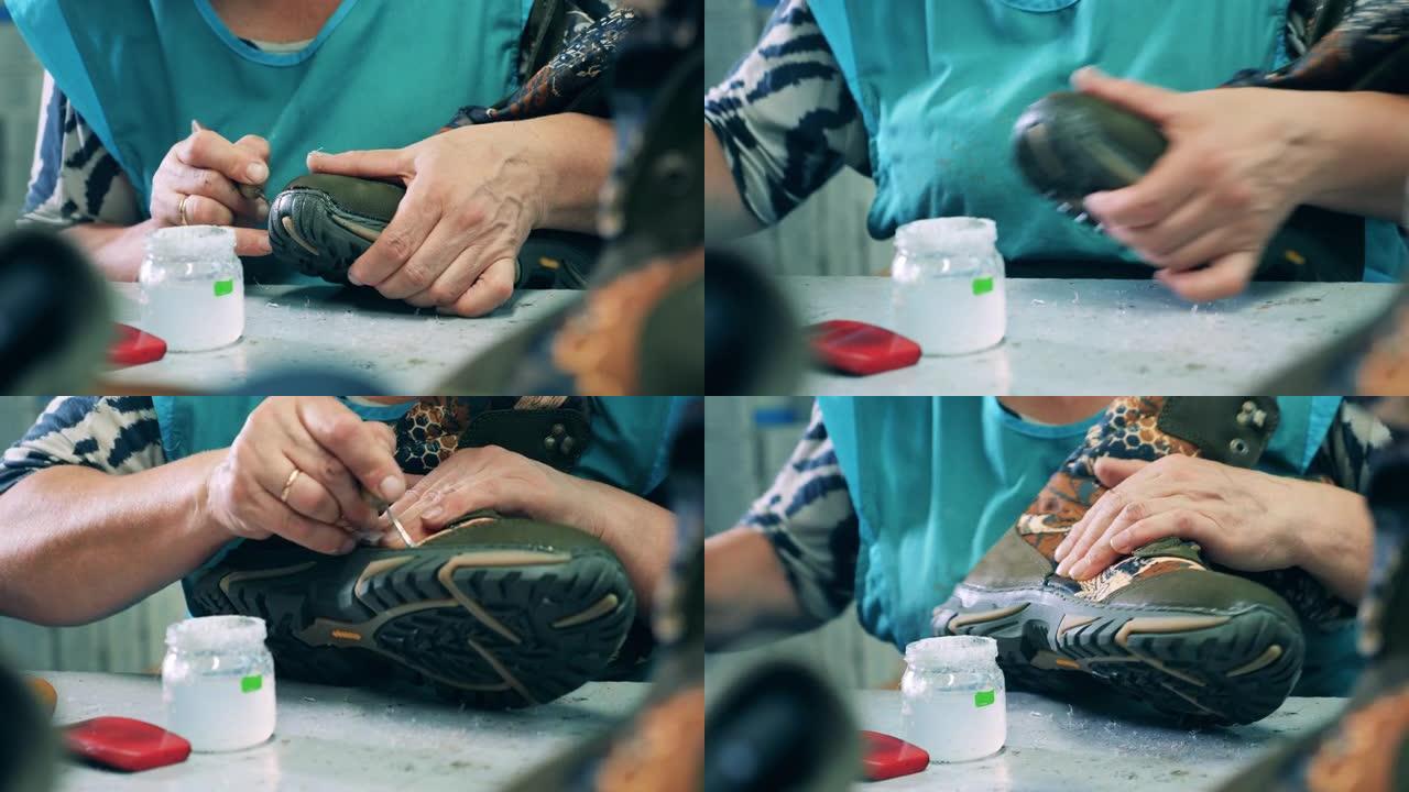 女工在制造过程中将胶水涂在靴子上