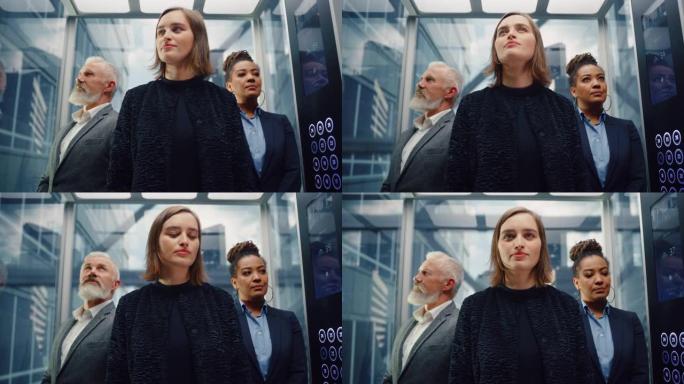 三个不同的多民族国际人士乘坐玻璃电梯在一个现代化的商务中心办公。专注于一个快乐的年轻漂亮的女商人站在
