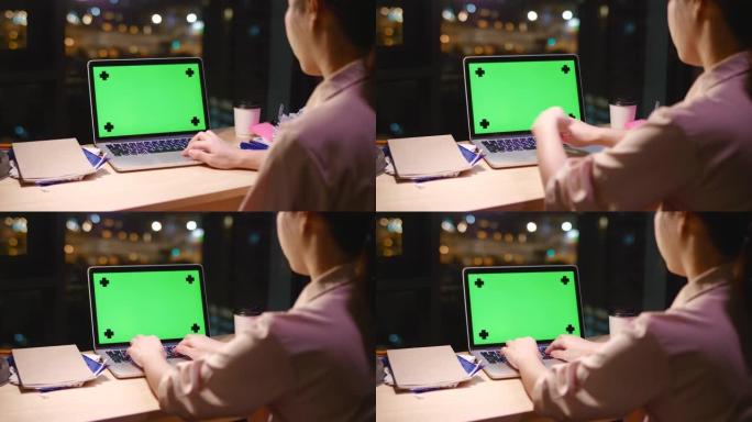 女人晚上使用笔记本电脑绿屏电脑
