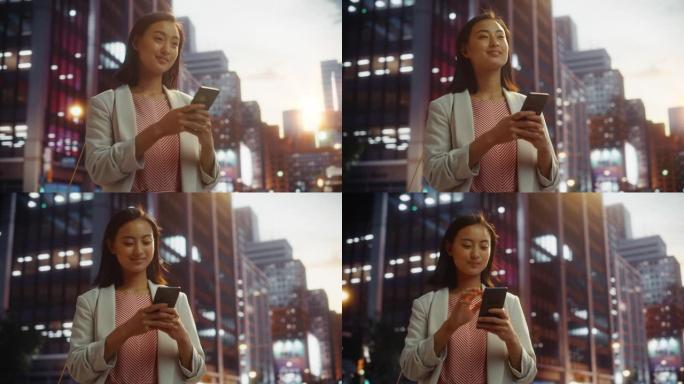 一位美丽的日本女性在日落时穿着时髦的休闲服并使用智能手机的肖像。时尚的女人在网上与人联系，传递信息和