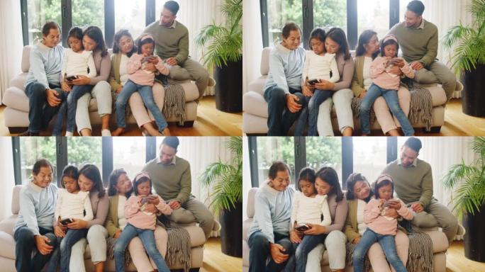 幸福多样的家庭纽带，在一起放松的同时，使用手机在线玩游戏和观看视频。小女孩在网络上播放动画片，同时与