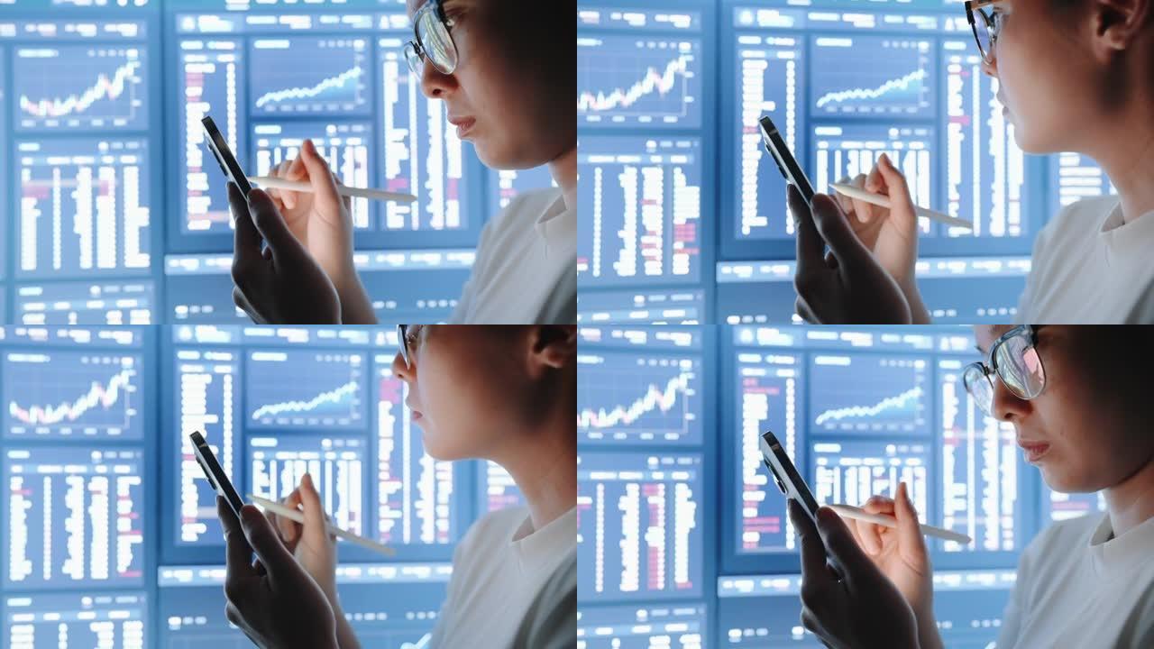 亚洲女性分析数据股市，大型电脑显示器或显示器上的财务数字