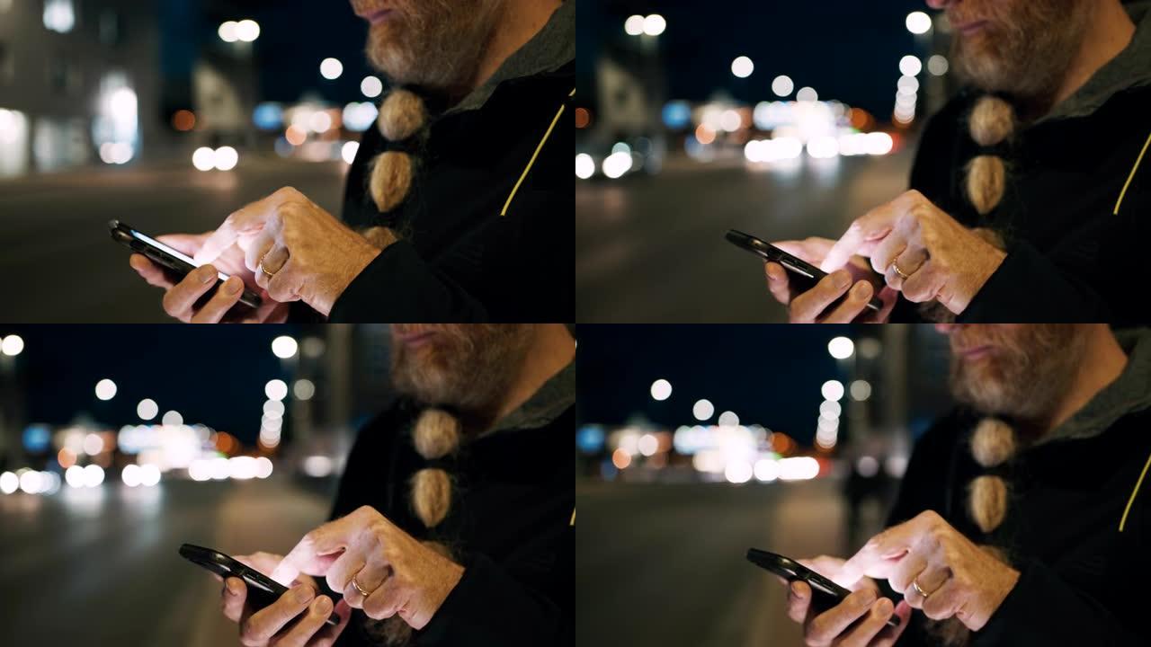 晚上，在城市的人行道上使用智能手机，留着长胡须的男子女士