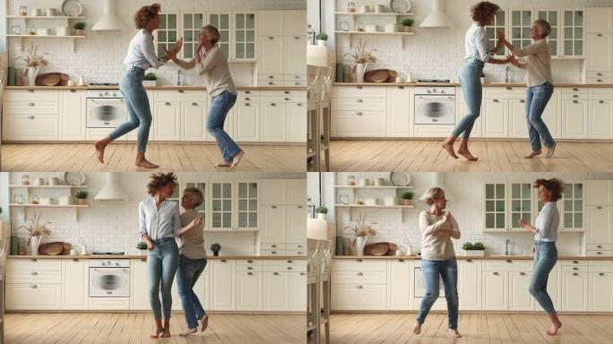 活泼的年轻女子与年迈的母亲在厨房跳舞