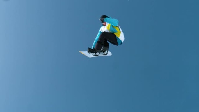 慢动作: 年轻的男性滑雪者捕捉大空气并进行旋转技巧。
