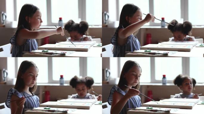 两个多种族的小女孩一起参加艺术课