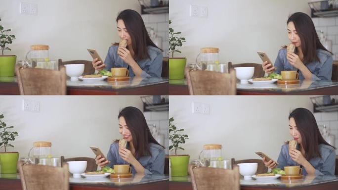 亚洲中国美女在家享用早餐，吃面包花生酱和咖啡