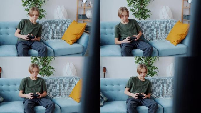 快乐的十几岁的男孩玩电子游戏，使用控制器按钮和在家微笑