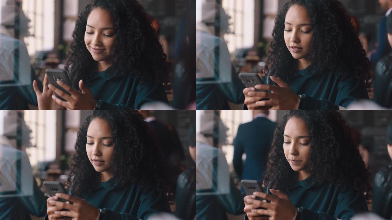 美丽的少女在咖啡馆使用智能手机发短信在社交媒体上分享信息，享受移动技术在咖啡店放松