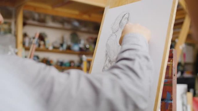 在室内美术课上用铅笔绘制的男性手绘图片特写