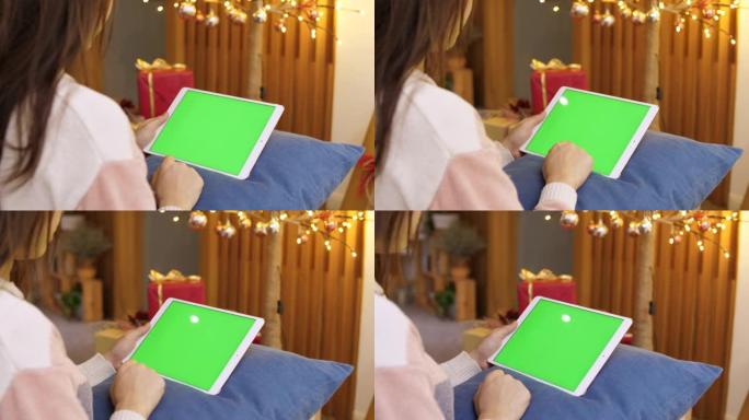 快乐圣诞女人使用数字平板电脑绿屏