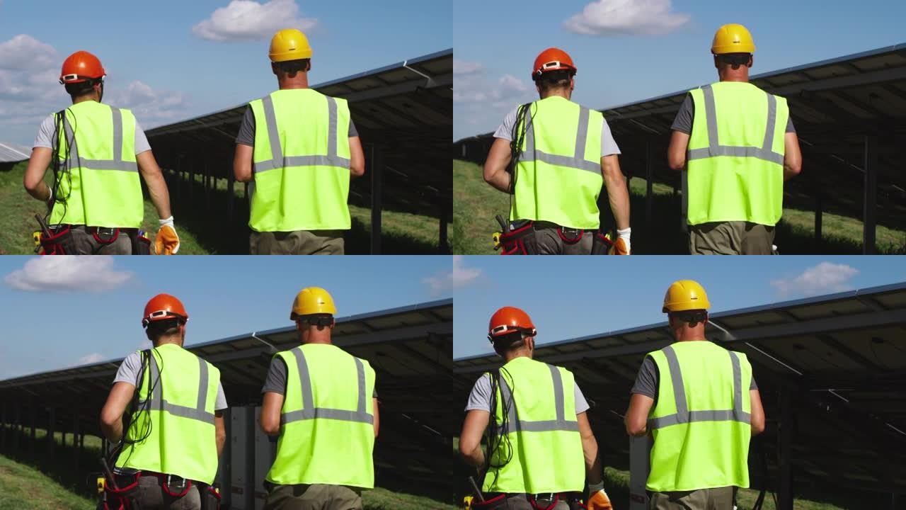 无法识别的工人一起检查太阳能电池板