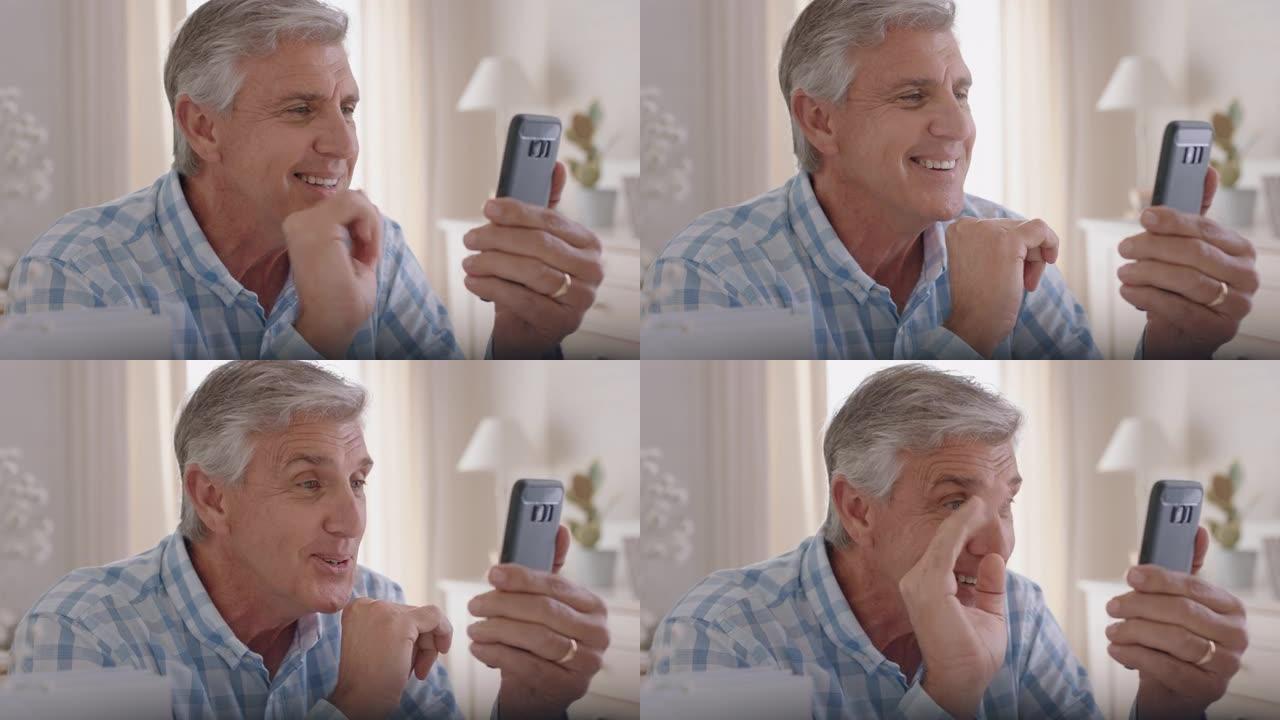快乐的成熟男人使用智能手机进行视频聊天祖父向婴儿挥手，喜欢在手机4k镜头上与孙子聊天
