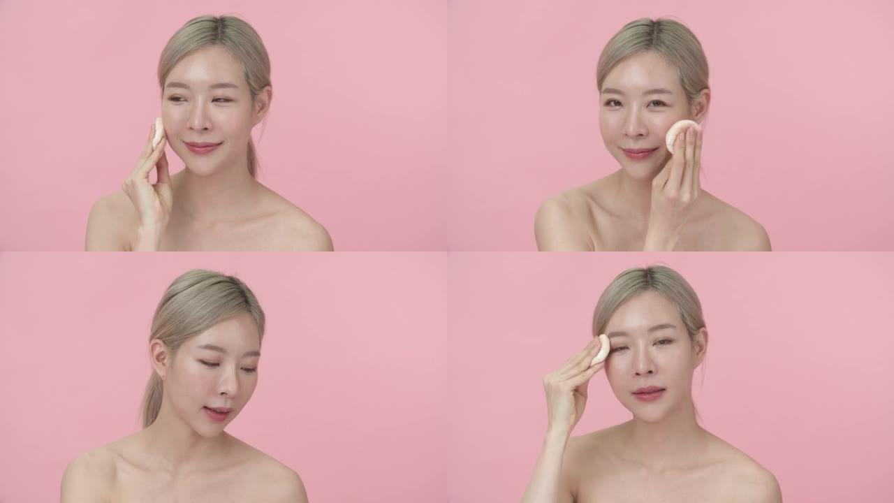 美丽的亚洲女人在脸上化妆粉扑的肖像。