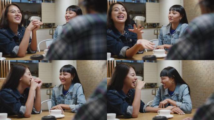 一群快乐的亚洲年轻朋友玩得开心，一起坐在咖啡馆餐厅笑着享受美食。