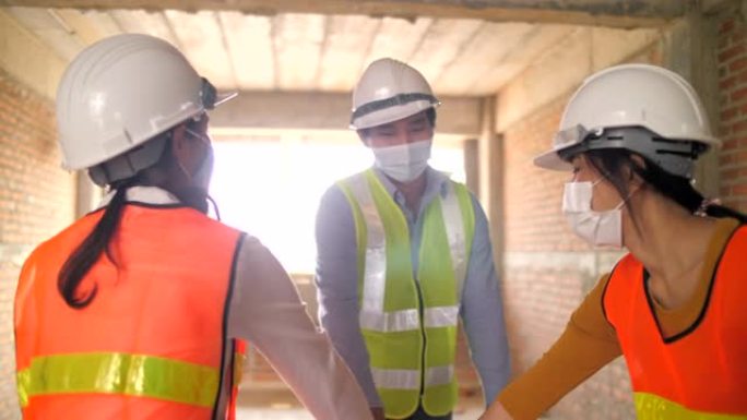 一群在建筑工地工作并戴着口罩的团队工人