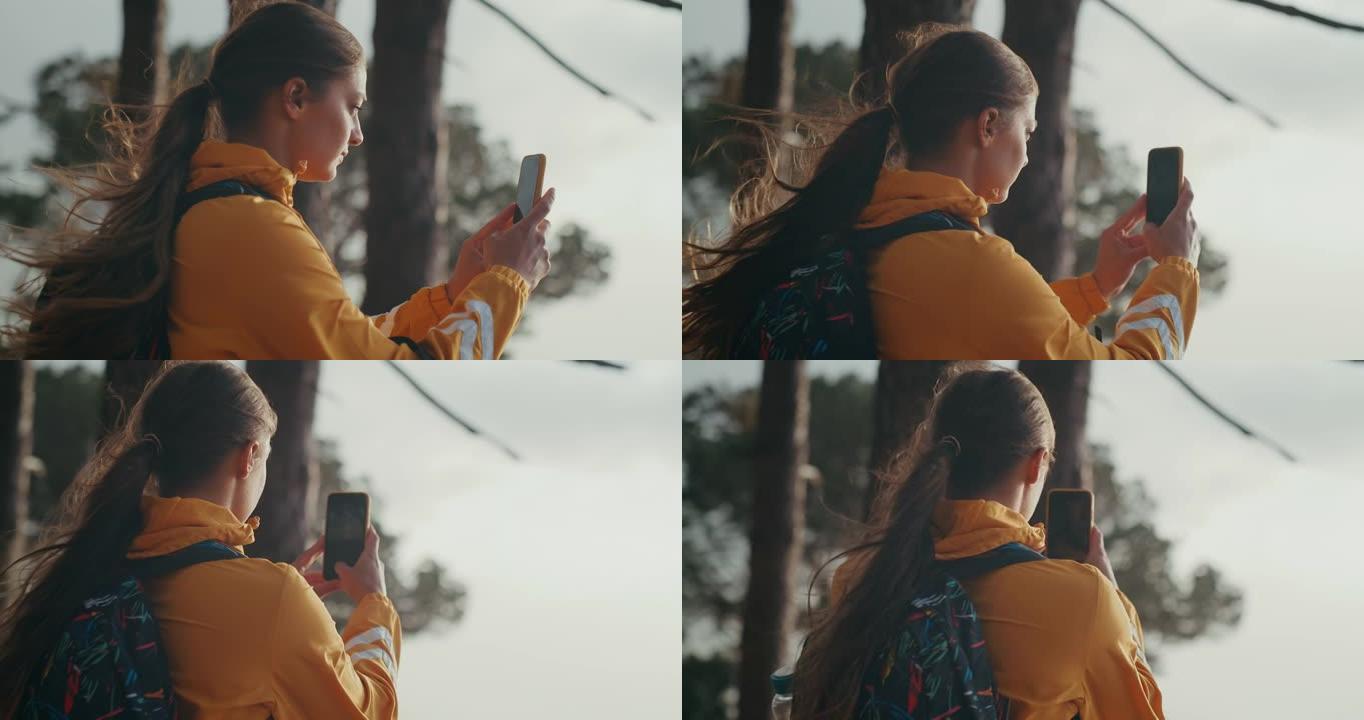 4k视频片段，一名妇女在远足时拍照