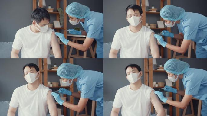 年轻的亚洲女护士给男性病人注射新型冠状病毒肺炎或流感抗病毒疫苗戴口罩保护病毒疾病坐在客厅的沙发上。
