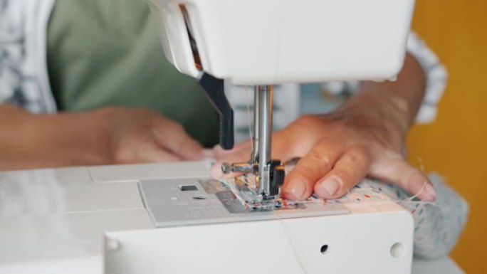 室内现代机器设计师手缝衣布的慢动作特写