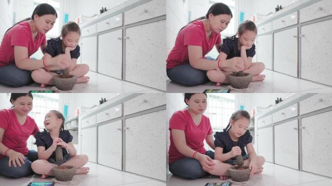亚洲小女孩在帮妈妈在厨房做饭