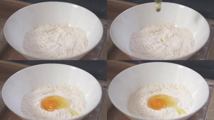 鸡蛋掉进面粉堆里。慢动作