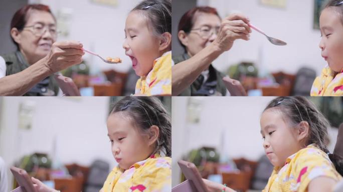 亚洲家庭祖母为孙女喂养食物