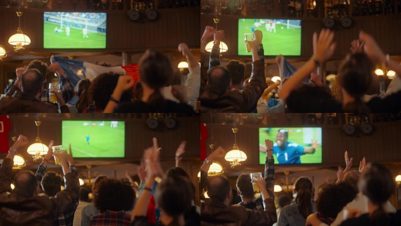 一群多元文化的朋友在体育酒吧观看电视直播足球比赛。快乐的球迷欢呼雀跃。年轻人庆祝球队进球并赢得世界杯