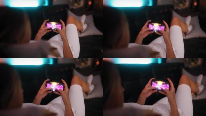 女人在她的智能手机上玩手机游戏