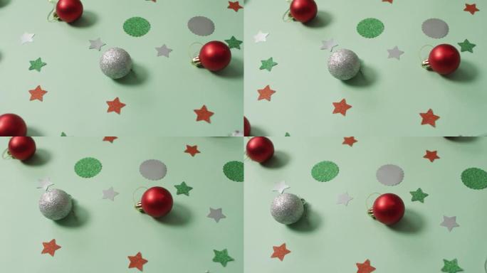 绿色背景上有银色和红色摆设的圣诞装饰品