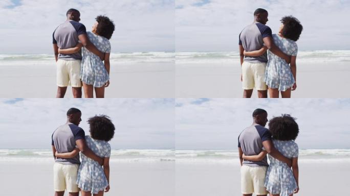 非裔美国夫妇在海滩上拥抱和微笑