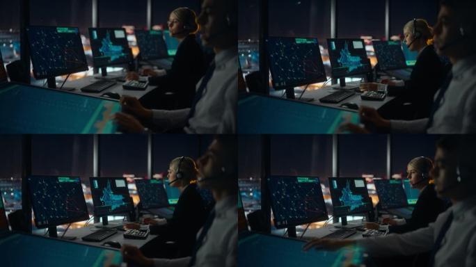 晚上，戴着耳机的女性空中交通管制员在机场塔楼通话。办公室里满是台式电脑显示屏，配有导航屏幕，飞机飞行