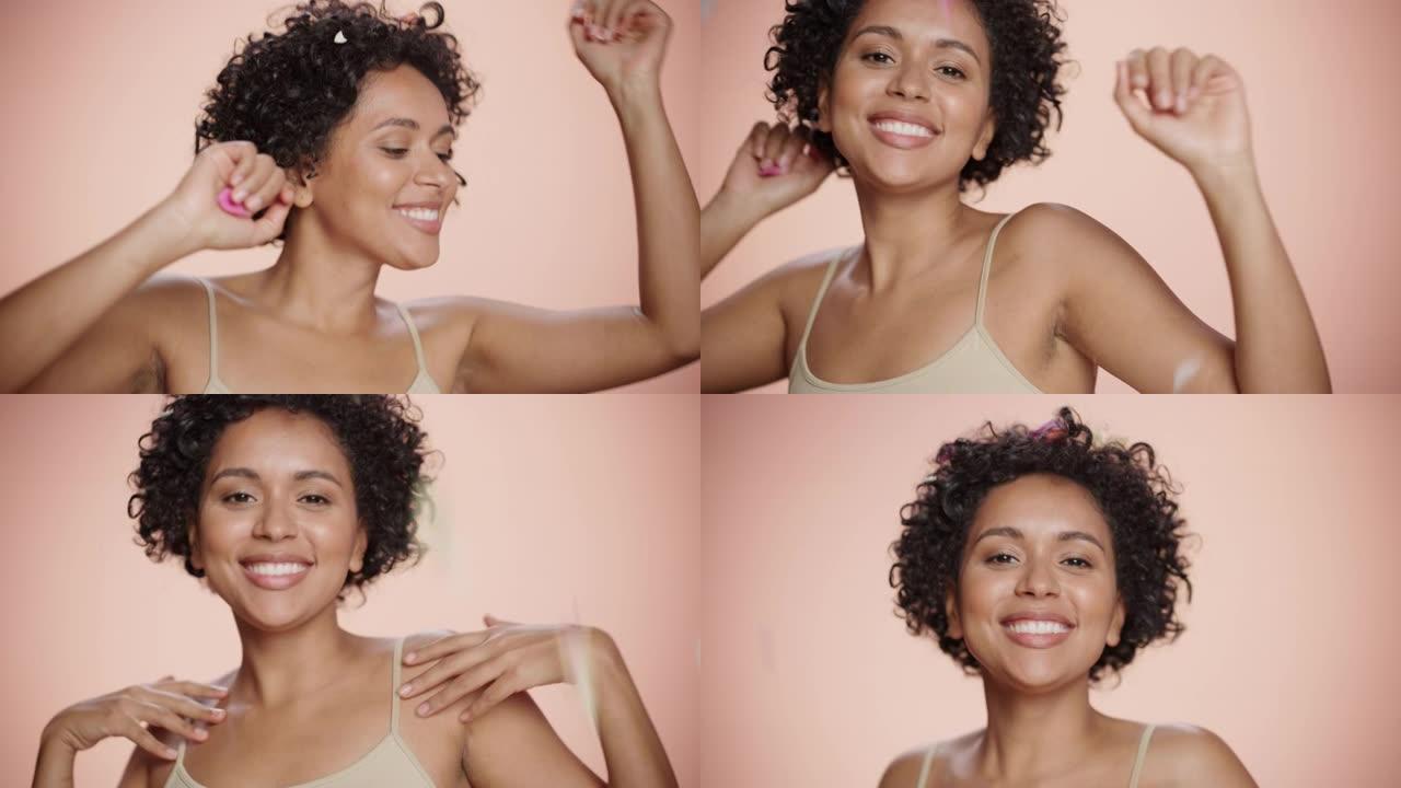 女性美丽的肖像。快乐快乐的多民族黑人妇女跳舞在掉落的粉红色花瓣。健康，健康，水疗和天然护肤概念在软孤