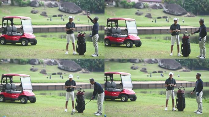 亚洲中国成熟成人从高尔夫球袋中选择驾驶员高尔夫球杆开球，并在高尔夫球场开球点指导他的儿子
