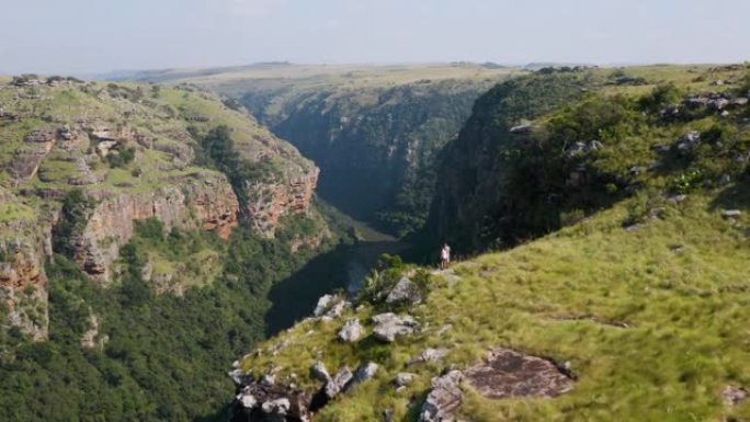 在南非东开普省姆坎巴蒂自然保护区观看宏伟的Msikaba峡谷的游客的鸟瞰图