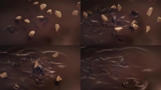 榛子碎片在4k超慢动作中落入液体巧克力中