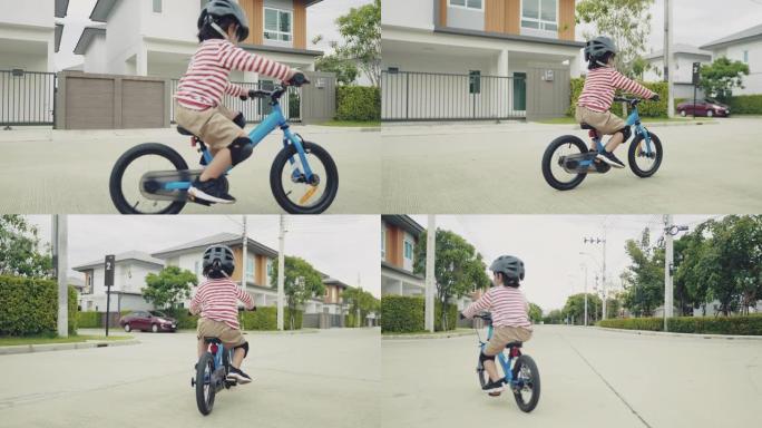 在街上骑平衡自行车的孩子。