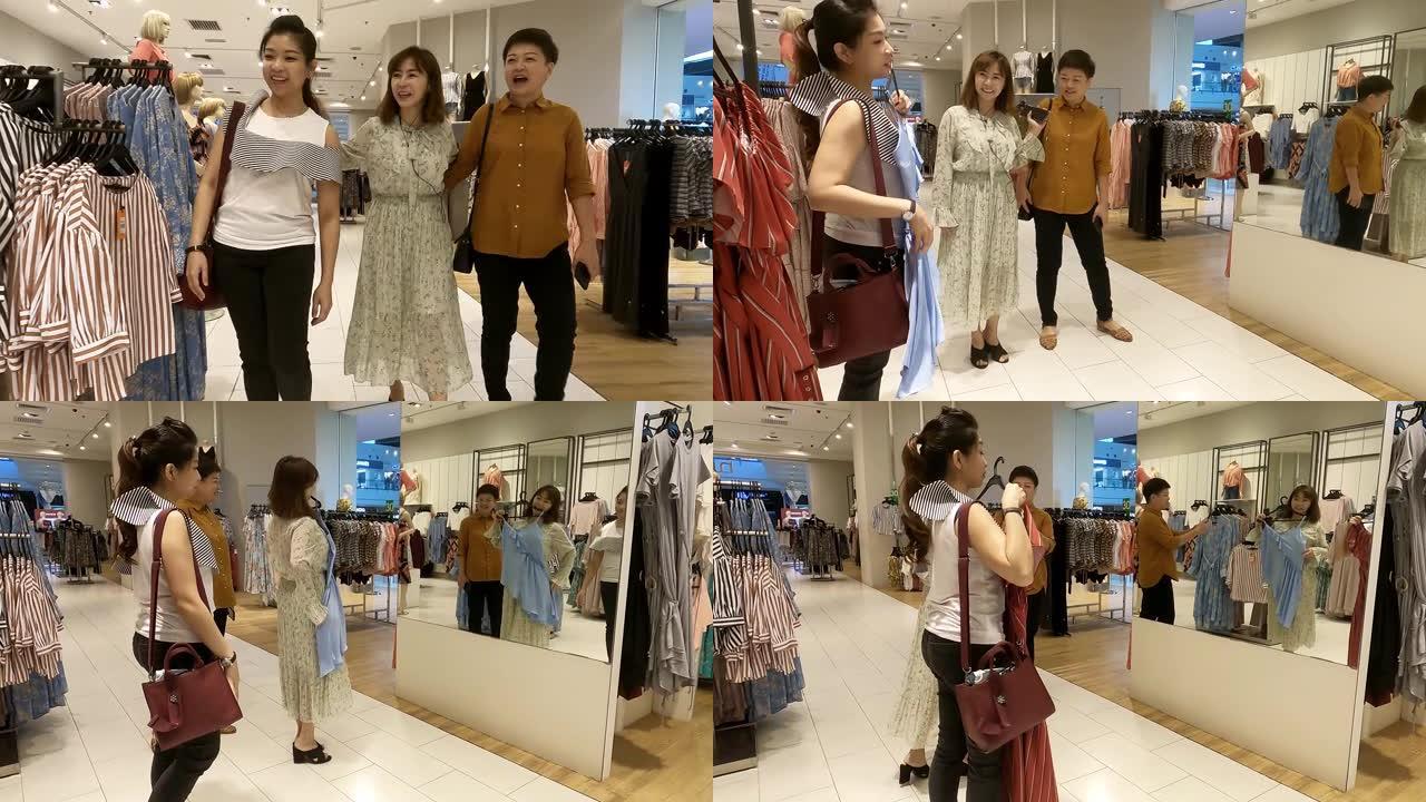 亚洲华人女性在服装店看镜选择衣服