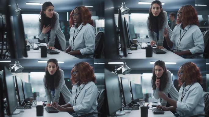 两个不同的同事在忙于团队项目时交谈。非洲女设计师与项目经理交谈。技术实验室中的团队合作
