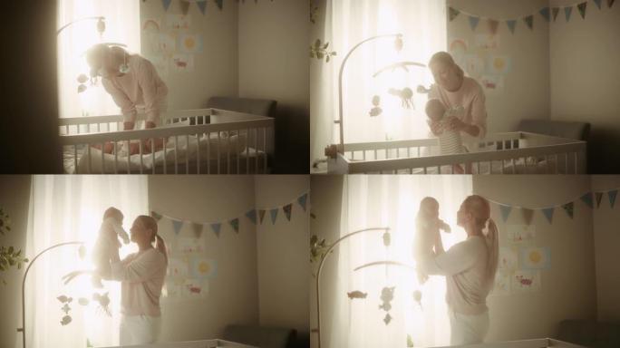 在舒适温暖明亮的房间里，一个可爱的新生婴儿躺在婴儿床上的真实镜头。快乐的母亲从卧室里接小孩。童年、新
