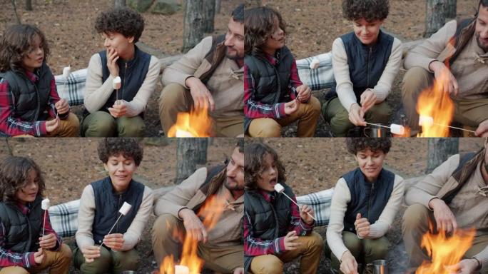 爸爸妈妈和儿子在森林里烧烤和吃棉花糖聊天在火中玩耍