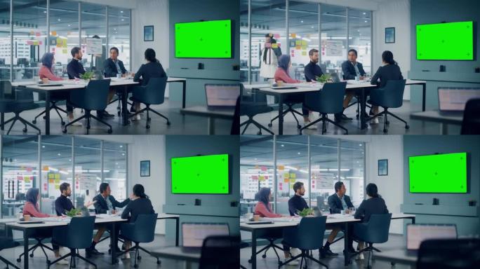 商人在办公室会议室使用绿屏电视。在Big Table的创意企业家团队进行讨论，集思广益。多民族专家从