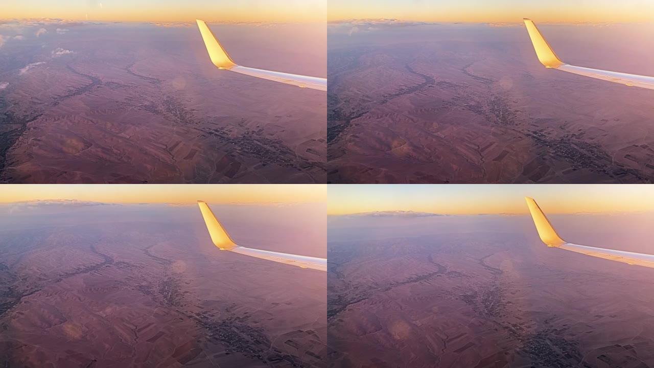 坐飞机飞行。日落时飞机机翼的视图