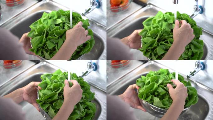 特写女人的手在家用厨房洗蔬菜健康食品概念