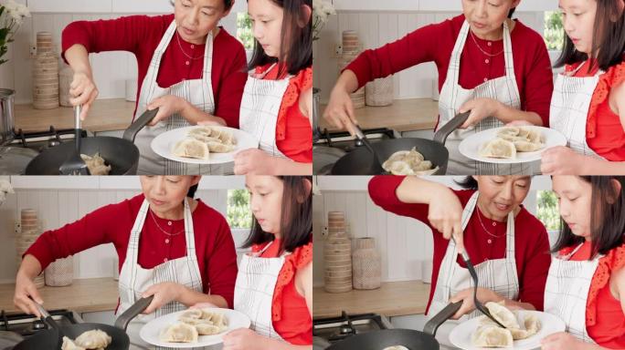 家庭，孩子和亚洲妇女和女孩一起在家里的厨房里煮饺子。食物，饭菜和美食，母女在房子里结为纽带时学习烹饪