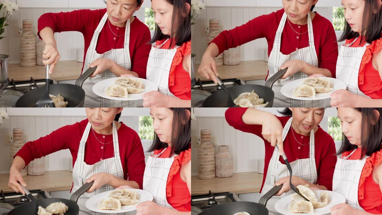 家庭，孩子和亚洲妇女和女孩一起在家里的厨房里煮饺子。食物，饭菜和美食，母女在房子里结为纽带时学习烹饪