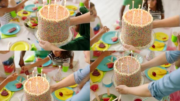 儿童派对上的生日庆祝蛋糕，装饰有趣、多彩的。男孩与朋友一起庆祝他的特殊日子或场合，吹灭蜡烛，享受甜蜜