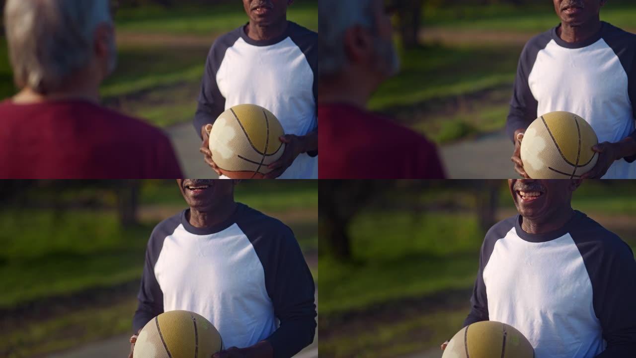 老年活跃男子在户外手持旧篮球的特写